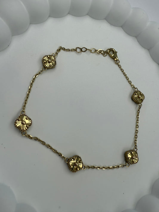Pulsera de flores negra y dorada 10K